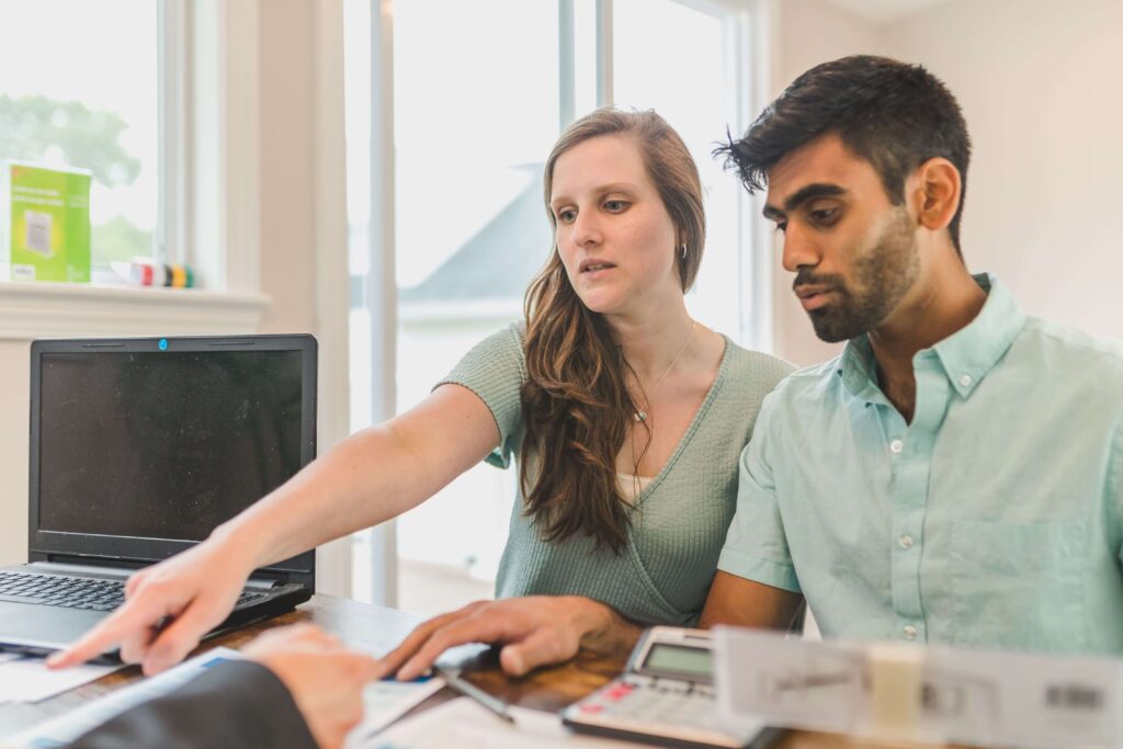 A couple reviewing bank statements together during a monthly finance check-in