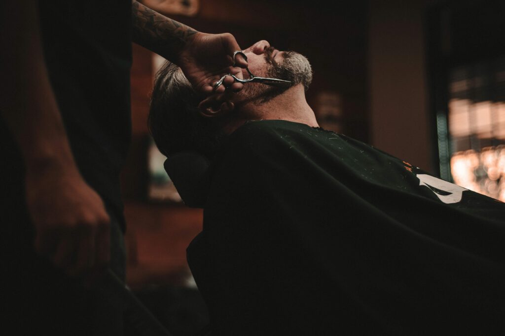 Man using a home hair and beard trimmer to save money on haircut